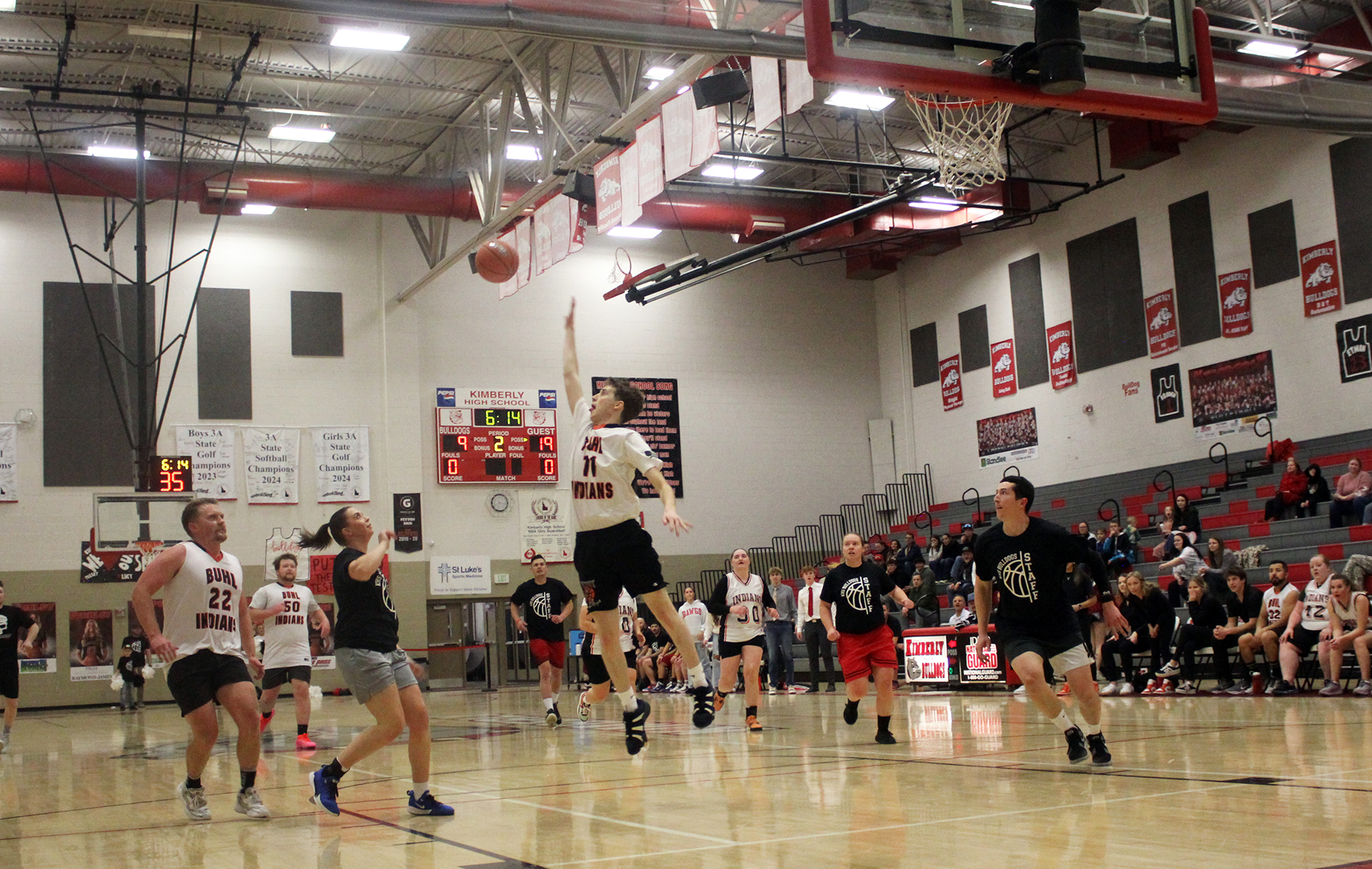 Team Kimberly's Callie Taylor (left) oops the ball to Jeremy Jenkins (right) during the staff basketball game vs. Buhl on Tuesday, Feb. 18. | Photo by Paco de Asis Medina Olea