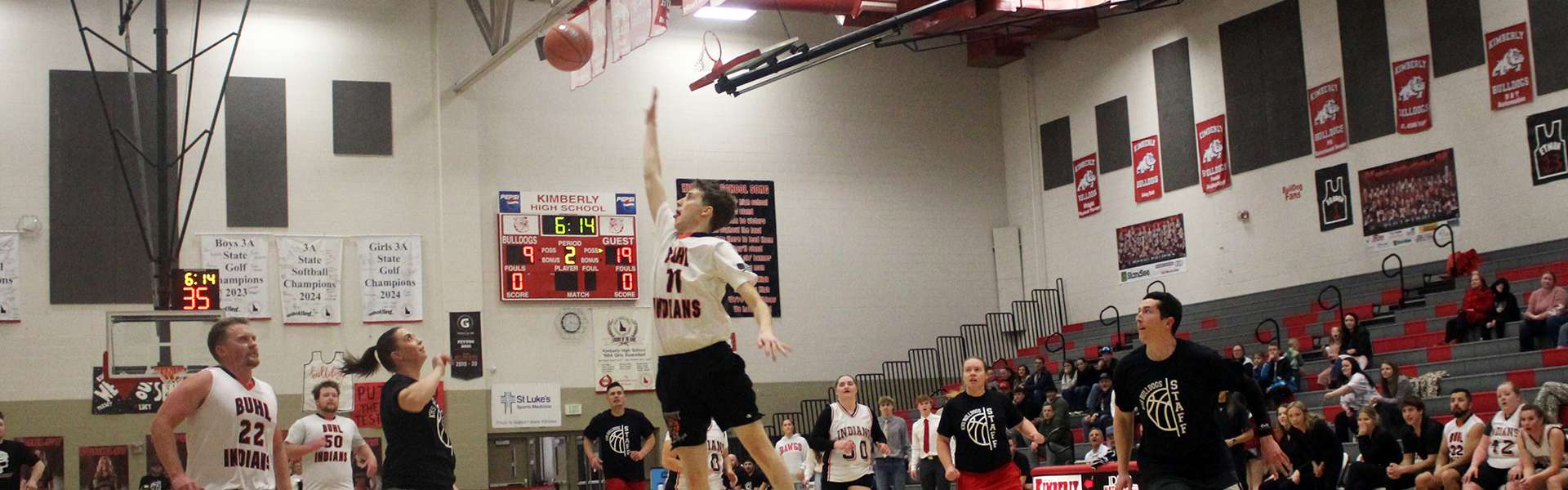 Team Kimberly's Callie Taylor (left) oops the ball to Jeremy Jenkins (right) during the staff basketball game vs. Buhl on Tuesday, Feb. 18. | Photo by Paco de Asis Medina Olea