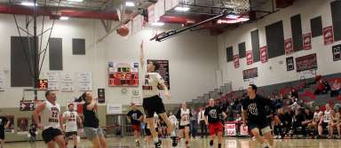 Team Kimberly's Callie Taylor (left) oops the ball to Jeremy Jenkins (right) during the staff basketball game vs. Buhl on Tuesday, Feb. 18. | Photo by Paco de Asis Medina Olea