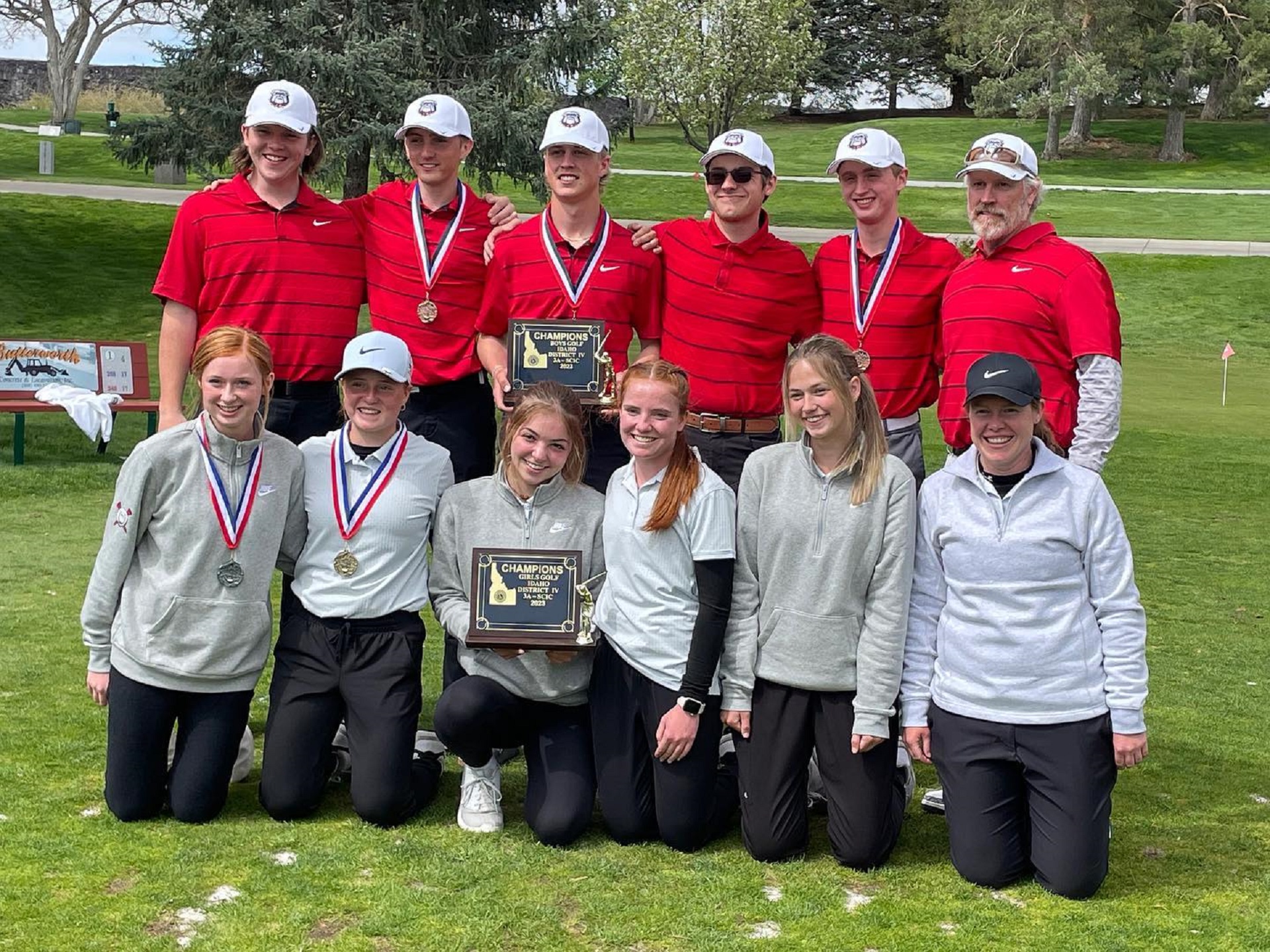 The KHS girls and boys golf teams pose with their district championship plaques. | Photo via Kimberly Booster Club