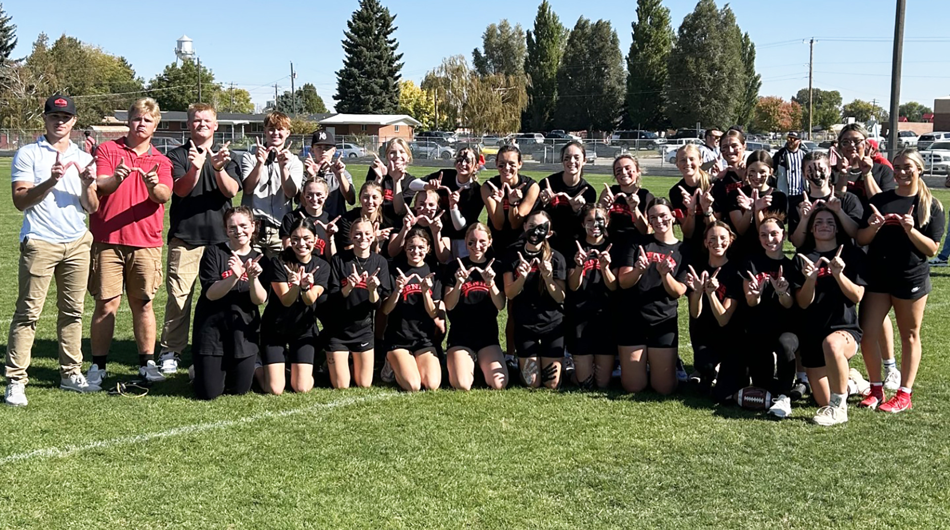 The senior girls Powderpuff team and coaches pose after their win. | Photo by Anna Solomon