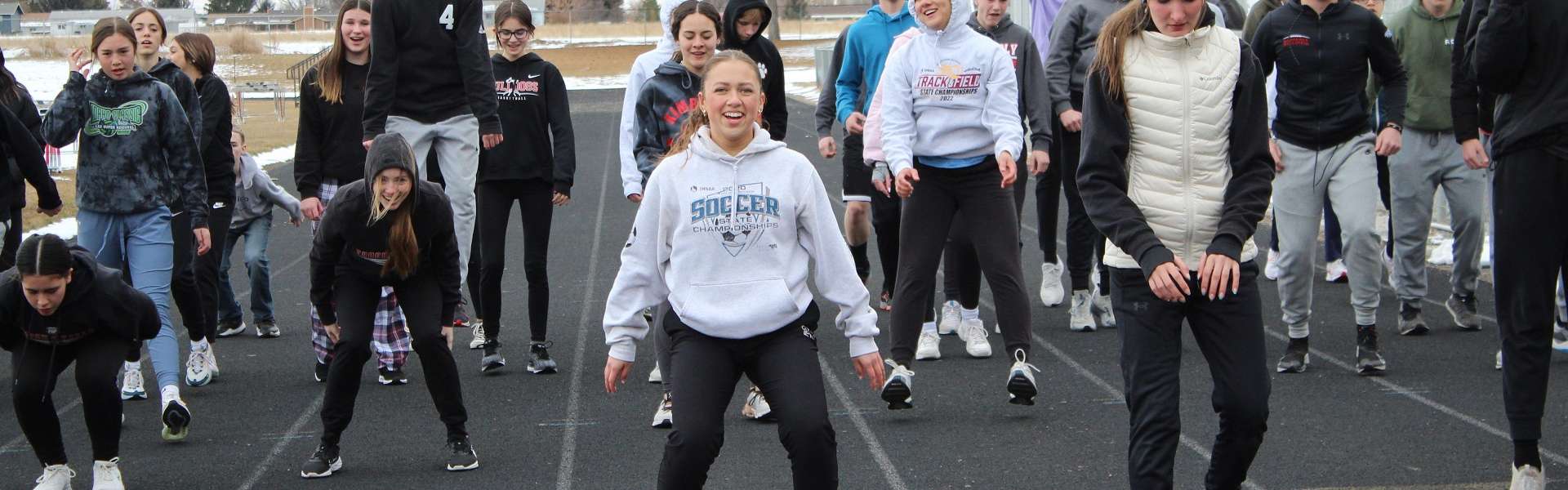 Senior Emily Ramirez and other members of the track and field team warm up during a cold practice this spring. | Photo by Kaya Thomas