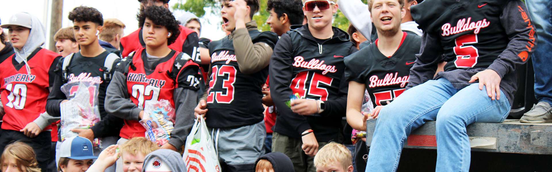 Members of the varsity football team celebrate during the parade on Friday, Sept. 22. | Photo by Jacey Cypriano