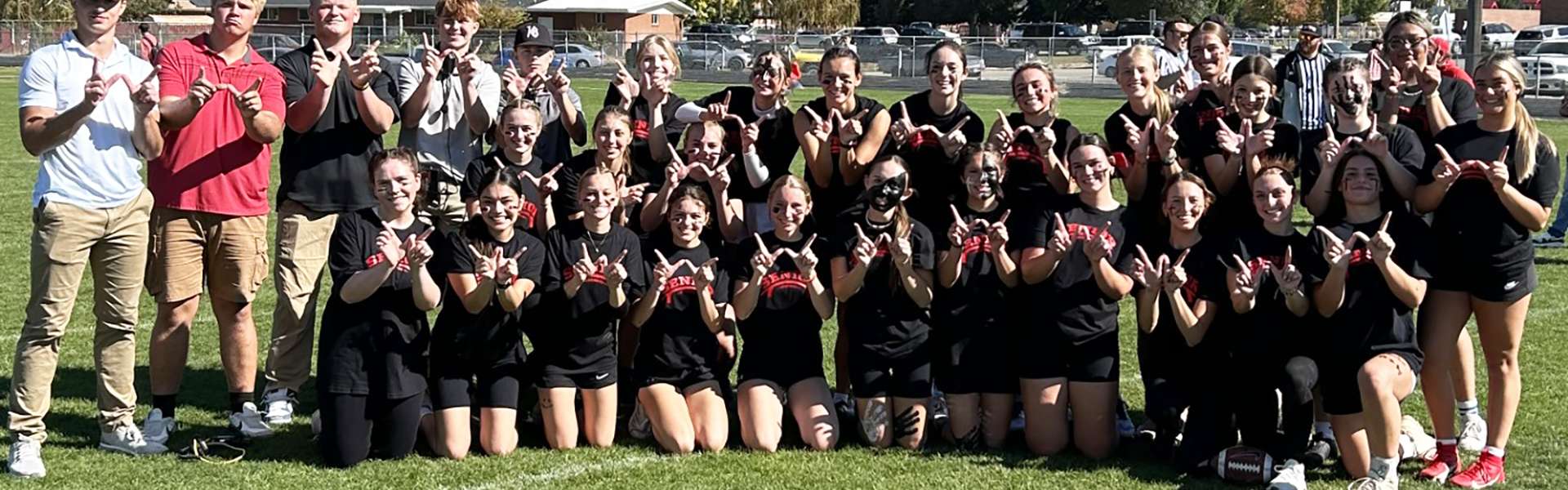 The senior girls Powderpuff team and coaches pose after their win. | Photo by Anna Solomon