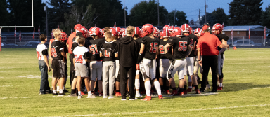 The KHS football team talks during a timeout during a game against Fruitland. | Photo by Hayley Daniels