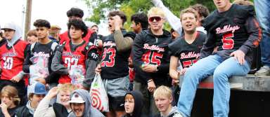 Members of the varsity football team celebrate during the parade on Friday, Sept. 22. | Photo by Jacey Cypriano
