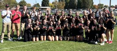 The senior girls Powderpuff team and coaches pose after their win. | Photo by Anna Solomon